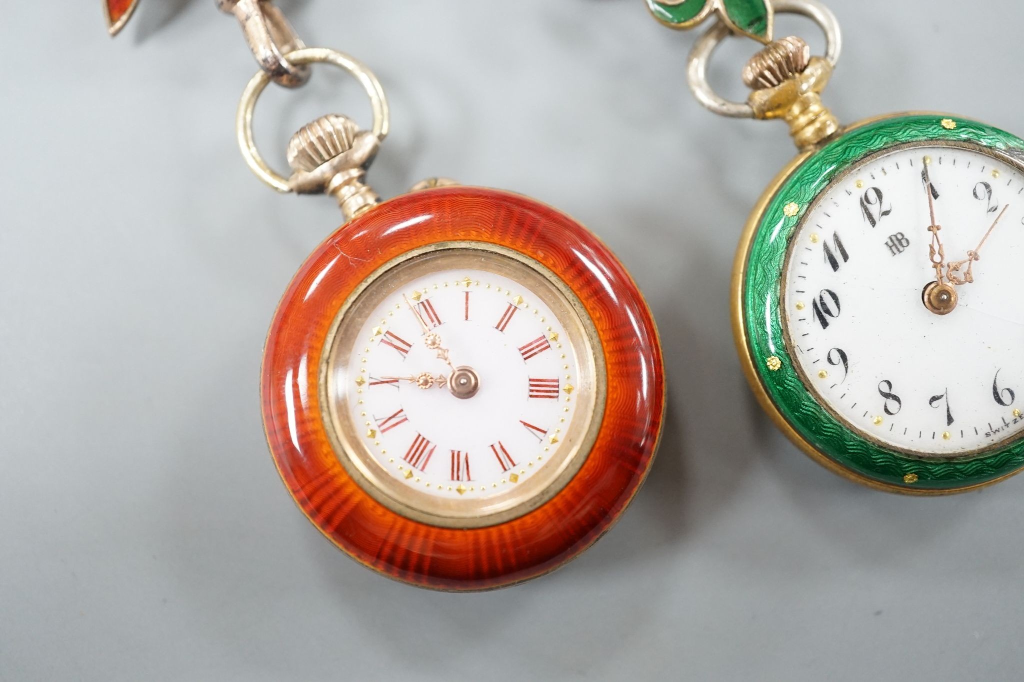 Two lady's early 20th century gilt metal and enamelled fob watches, on enamelled suspension brooches.